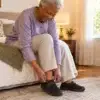 Senior woman putting on adaptive velcro shoes